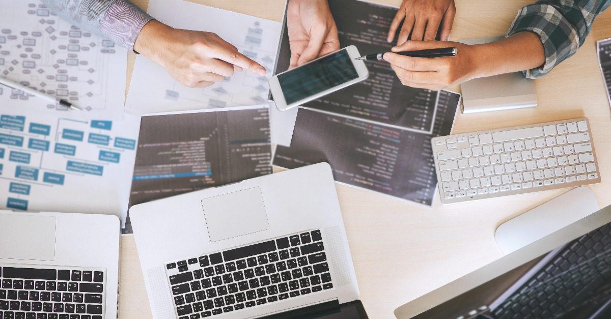 busy desk with website outlines and notes